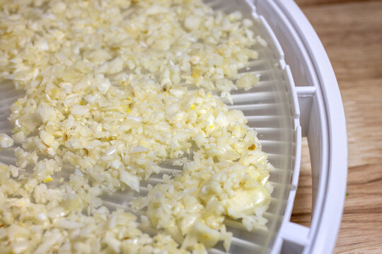 Crumbled Cauliflower laid on a dehydrating tray for food preservation