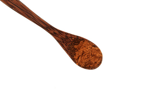 Aguaje flour in wooden spoon, close-up. Healthy ingredient for Aguajina drink, buriti wine and chupetes. Aguaje powder strong antioxidant