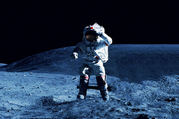 Astronaut on the moon, with the Earth in the background. Elements of this image furnished by NASA © Artsiom P