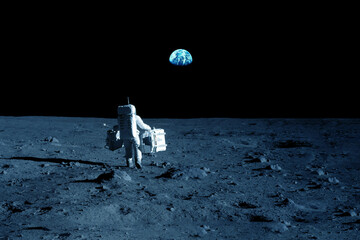 Astronaut on the moon, with the Earth in the background. Elements of this image furnished by NASA