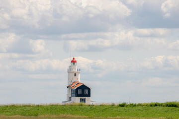 The Horse Of Marken Lighthouse with blue sky and white clouds, Paard van Marken on the Dutch...