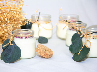 scented candles in glass jar with decorative elements