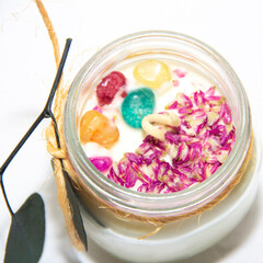 scented candles in glass jar with decorative elements