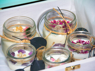 scented candles in glass jar with decorative elements