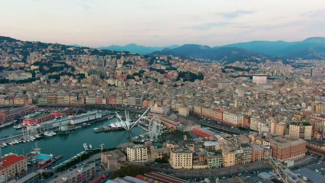 Panoramic Aerial view of Genoa Old Harbour with Aquarium, the Bigo and Biosfera. Typical Genova Landmark Skyline, Italy, Europe. Urban Travel and Architecture landscape. 4K zoom in drone shot