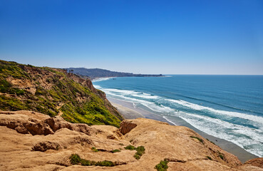 Steep, eroded cliffs with a zigzag path to Black's Beach, California. Scripps Pier and La Jolla...