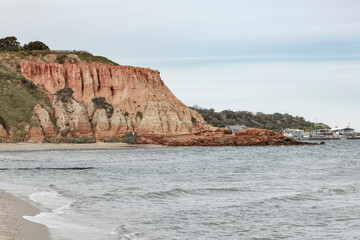 An ocean landscape scene with a rocky cliff