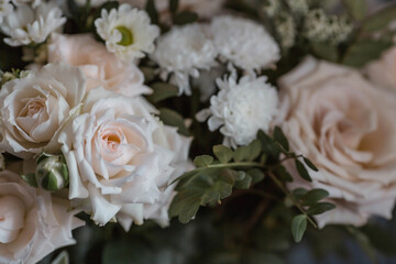 A beautiful bouquet of beige, cream roses and white chrysanthemums. Background floral image of pastel colors. Natural, environmentally friendly natural background. A copy of the place for the text.