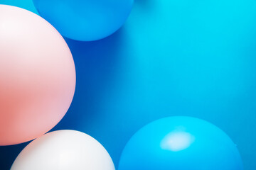 Blue background with colorful pink and white air balloons as frame, card with copy space