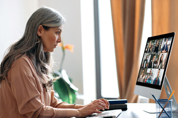 Virtual meeting, online business meeting. Serious asian mature gray-haired woman communicate with...