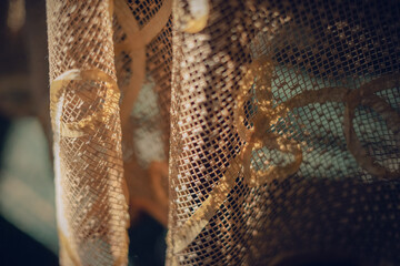 A piece of golden Lace fabric facing sunshine