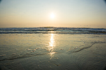 Fototapeta na wymiar Sunset sunrise on sea wave beach nature background