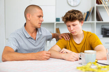 Obraz premium Portrait of guy with his father who are resting together at the home