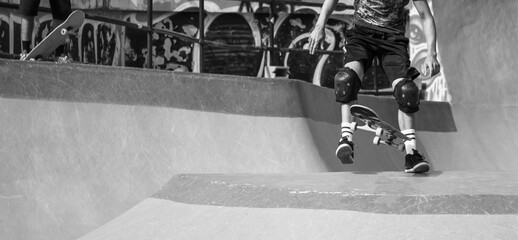 Skateboarder practicing in the skate park.
