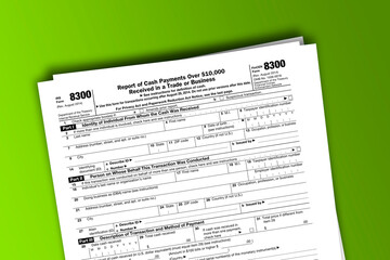 Form 8300 documentation published IRS USA 08.29.2014. American tax document on colored