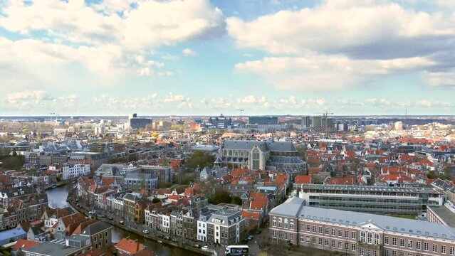 Aerial shot flying up over the ancient city of Leiden, revealing the Faculty of Law of Leiden University, the Pieterskerk and the Rapenburg canal