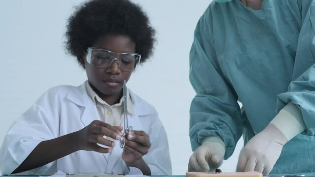 Education concept of 4k Resolution. Medical school students practicing suturing wounds in classroom. internship doctor. training simulation.