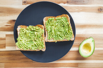 healthy plant-based food, basic plant-based smashed avocado toast with half avocado next to it