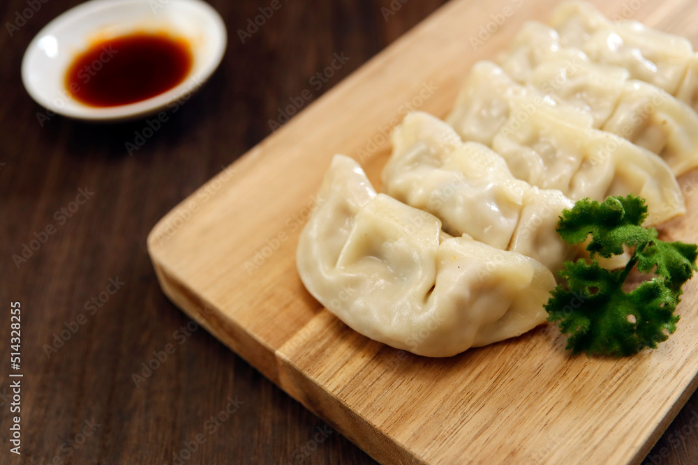 Wall mural Freshly baked dumplings with plenty of gravy on the table