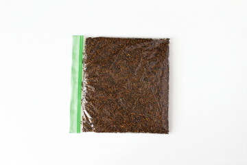  organic indian aromatic spice black cumin or kali jiri seeds in plastic bag,different name in various states in india,white background,top view   