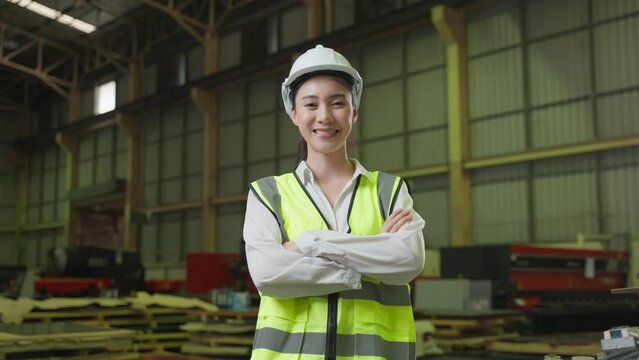 Portrait of Asian female industry worker working in factory warehouse