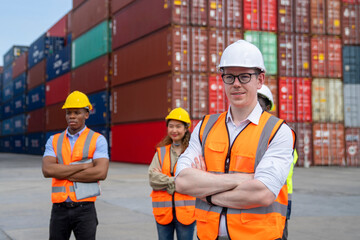 Group of engineer worker and manager standing in the shipping yard container.