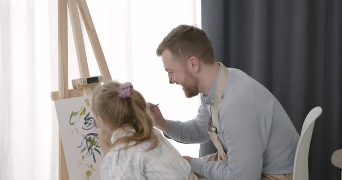 Father and daughter with down syndrome drawing together