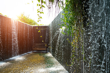 Flowing water like a small waterfall curtain. Water overflowing the mortar weir during the rainy...