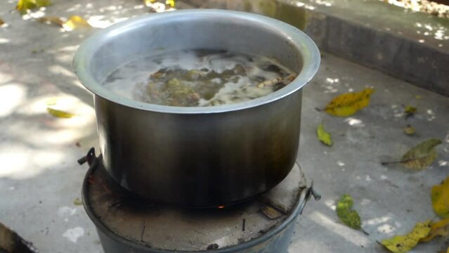 A close up shot of turmeric root being boiled in a big pot . Turmeric is a common spice that comes from the root of Curcuma longa. It contains a chemical called curcumin, which might reduce swelling.
