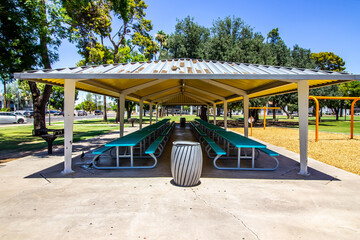 Fototapeta na wymiar Large Pergola With Picnic Tables At Free Public Park