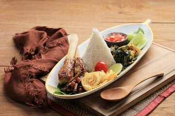 Nasi Campur Bali. Balinese Dish of Steamed Rice with Variety of Side Dishes, such as Sate Lilit, Ayam Pelalah, Telur Dadar, Kacang Teri, Jukut Urap.