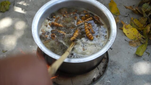 A close up shot of turmeric root being boiled in a big pot . Turmeric is a common spice that comes from the root of Curcuma longa. It contains a chemical called curcumin, which might reduce swelling.