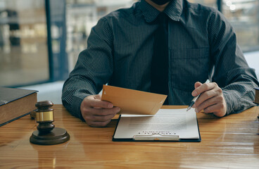 Law office lawyers working with hammers and scales with contract documents with legal tiger skins on consultant concept table.