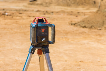 Construction site contractors use laser a trench for a concrete foundation construction measuring equipment to measure level