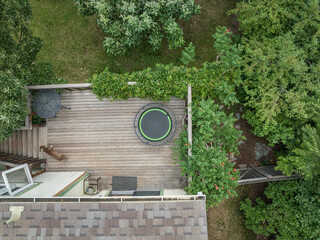 mini trampoline for fitness exercising and rebounding in a backyard patio, aerial view