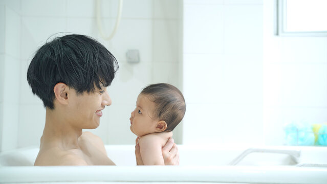 赤ちゃんをお風呂に入れる男性