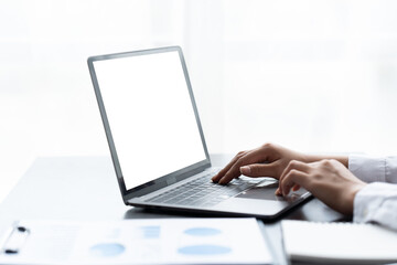 Mockup image of business woman using and typing on laptop with blank white screen.