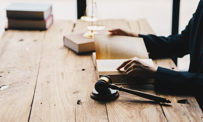 Close up lawyer businessman working or reading law book in office workplace for consultant lawyer concept.