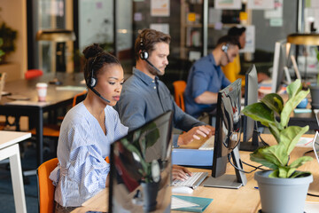 African american female customer service executive working with colleagues in office