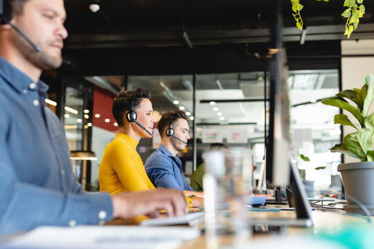 Young caucasian female customer service executive working on computer in office