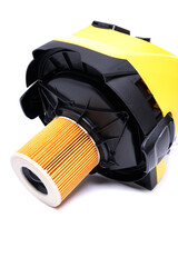Replaceable air filter on the cover of a yellow construction vacuum cleaner, isolate on a white background