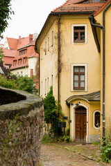 Fototapeta na wymiar Houses in old narrow street with cobble stones in Meissen, Germany
