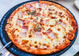 Homemade pizza with mozzarella cheese and bacon