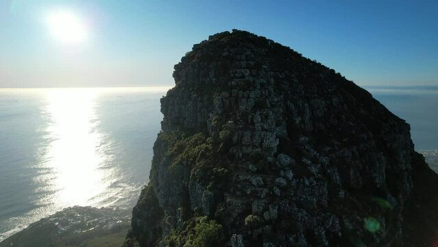 zoom in aerial top of Lions Head trail silhouette at sunset in Cape Town