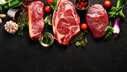 Variety of raw beef meat steaks for grilling.