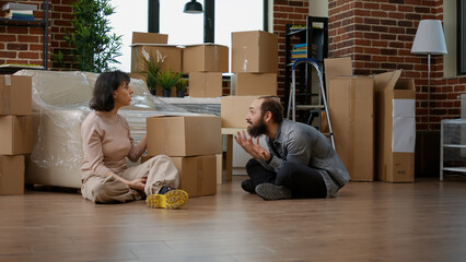 Angry couple having argument about new household decorations, fighting over mortgage...
