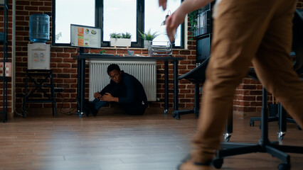 Panicked victim in office running away from scary undead monsters. Scared businessman hiding from...