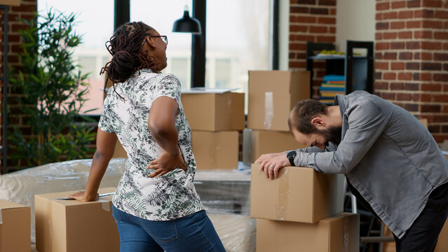 Life Partners Carrying Boxes Of Furniture To Move In New Real Estate Household, Buying First House Together. Moving Day As Proud Homeowners For Apartment Decoration. Handheld Shot.