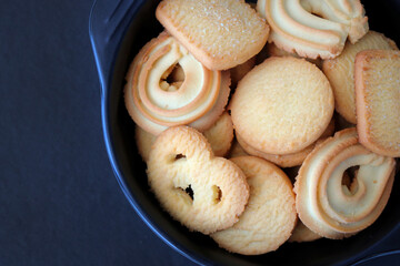 An overhead or flat lay view of Danish butter cookies in the traditional tin box. It's a Denmark delicacy consisting of butter, flour, and sugar. Danish chocolate chip biscuits. Copy space.
