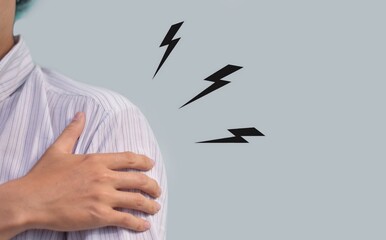 Pain in the shoulder joint of Asian man. Concept of frozen shoulder.